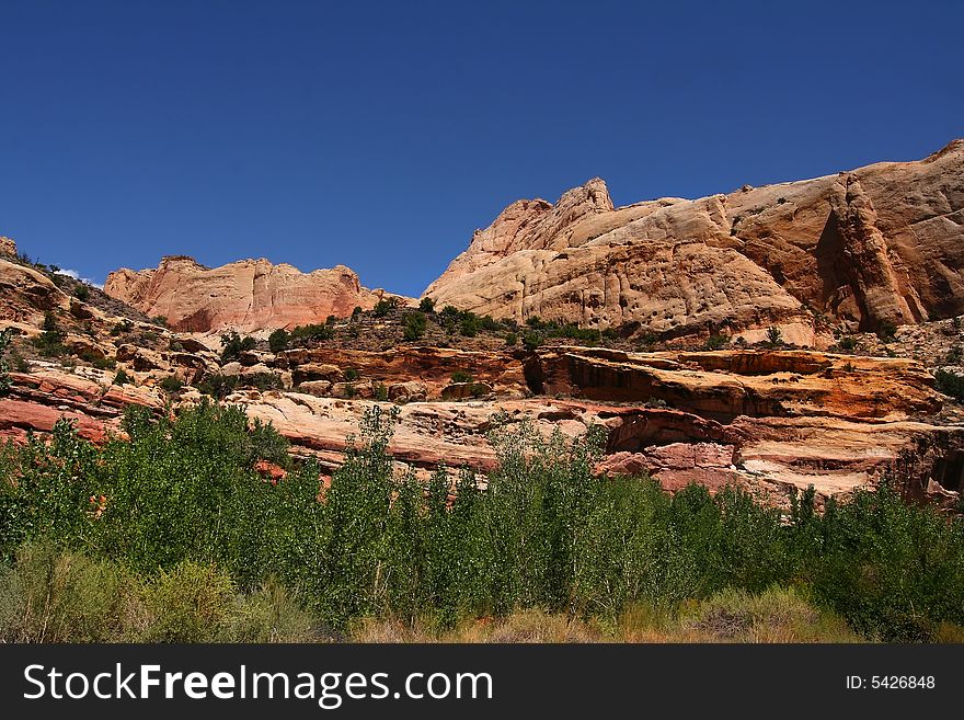View of the red rock formations in Capital Reef National Park with blue skyï¿½s and clouds. View of the red rock formations in Capital Reef National Park with blue skyï¿½s and clouds