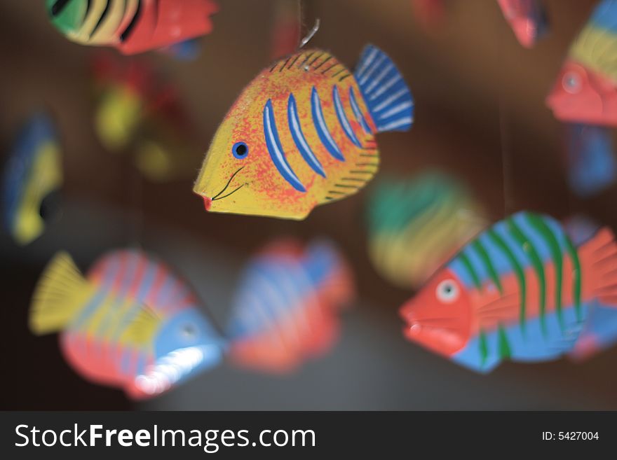 Flying colored fishes hand made with wood. Flying colored fishes hand made with wood
