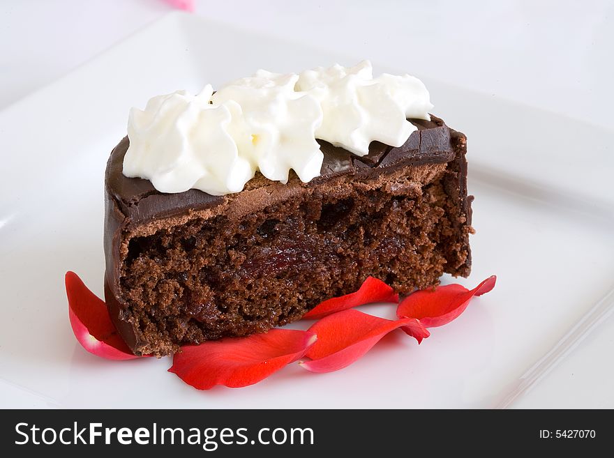 Chocolate cake on white dish with flower background. Chocolate cake on white dish with flower background