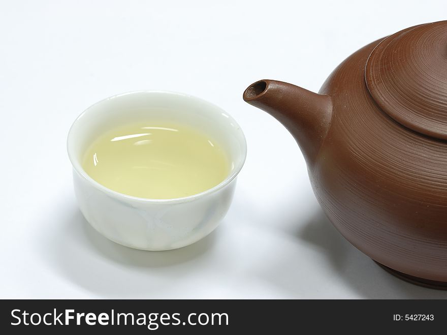 Isolated teapot and cup on white