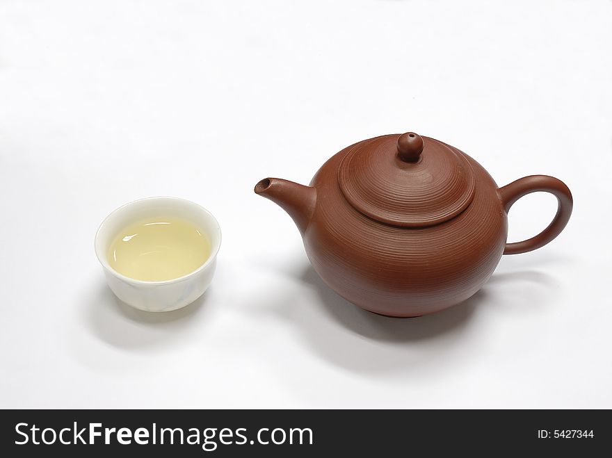 Isolated teapot and cup on white
