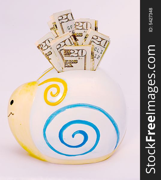 Snail shaped piggy bank stuffed full of twenty dollar bills. Snail shaped piggy bank stuffed full of twenty dollar bills