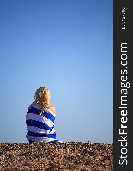 Young woman sits on a sand and meditate. Young woman sits on a sand and meditate.