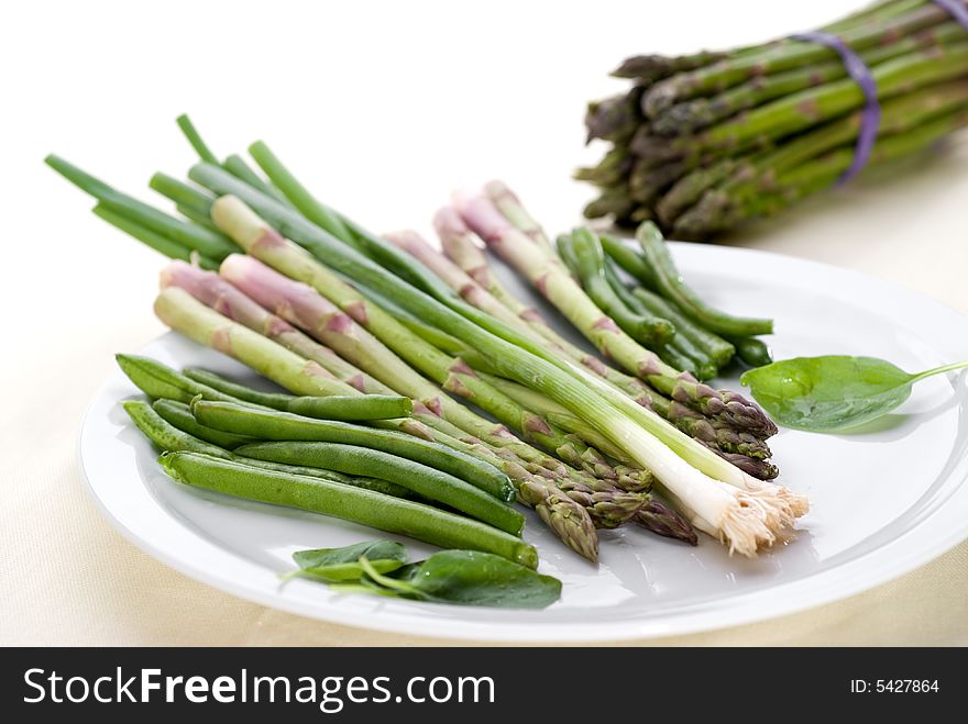 High key image of vegetables on a plate with shallow focus. High key image of vegetables on a plate with shallow focus