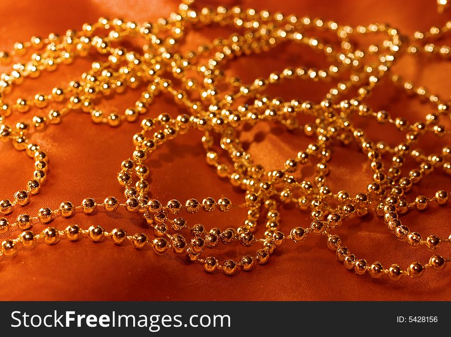 golden beads on silk background. golden beads on silk background