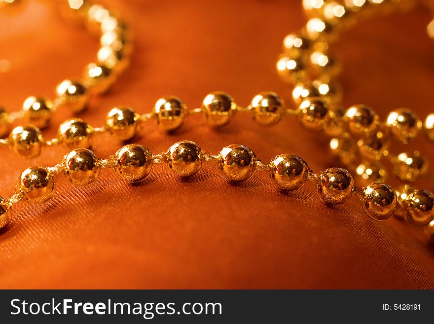 golden beads on silk background. golden beads on silk background