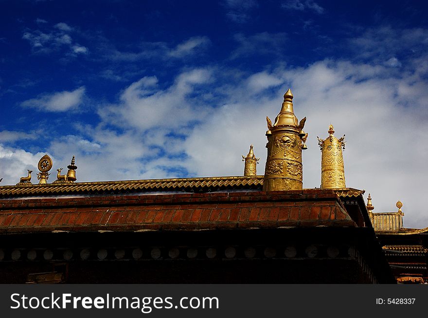 A Tibet religion temple under the sky, with gold tine atop. A Tibet religion temple under the sky, with gold tine atop.