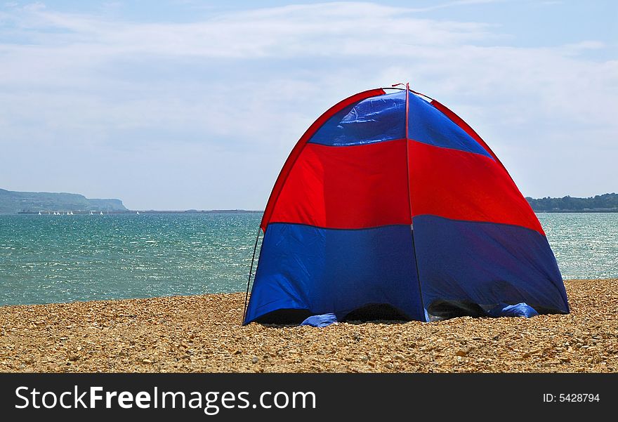 Tent pitched on a stoney beach. Tent pitched on a stoney beach