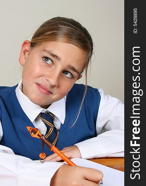 Teenage School girl busy with her homework, wearing uniform