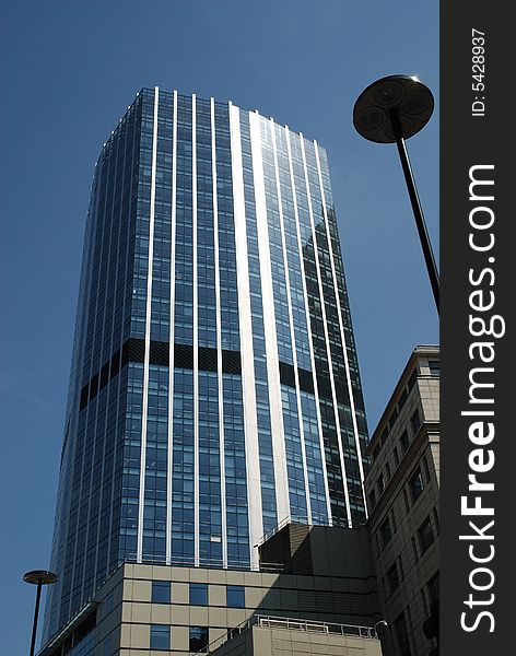 Canary Wharf office block skyscraper against a strong blue sky. Canary Wharf office block skyscraper against a strong blue sky.