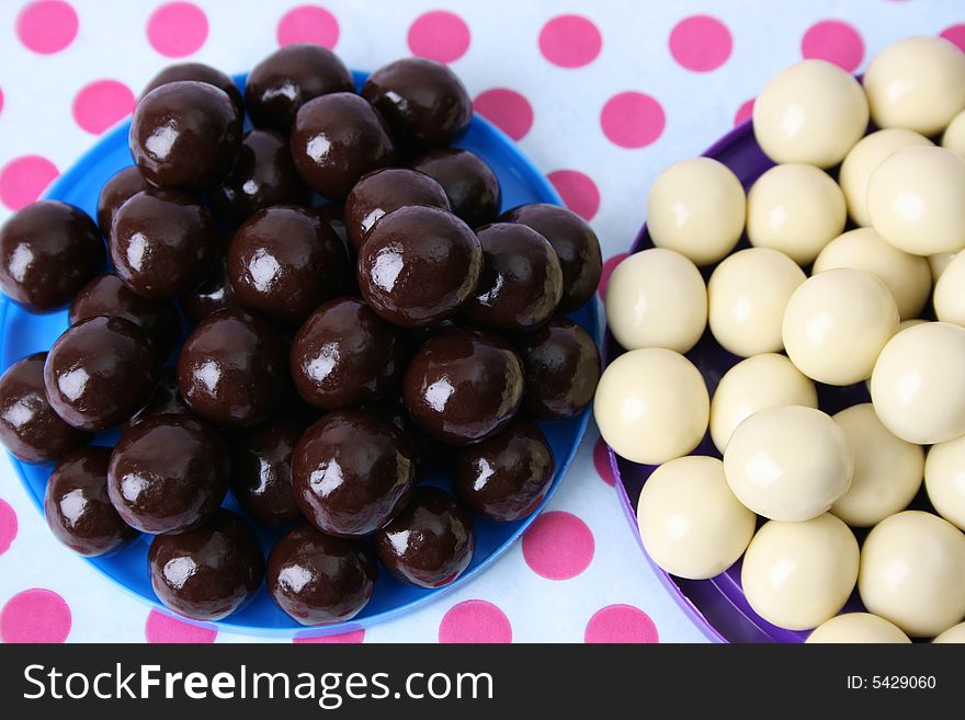 Vanilla and Dark Chocolate balls on a polka-dot background
