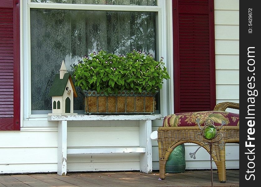 A front porch of a house in a small village. A front porch of a house in a small village.