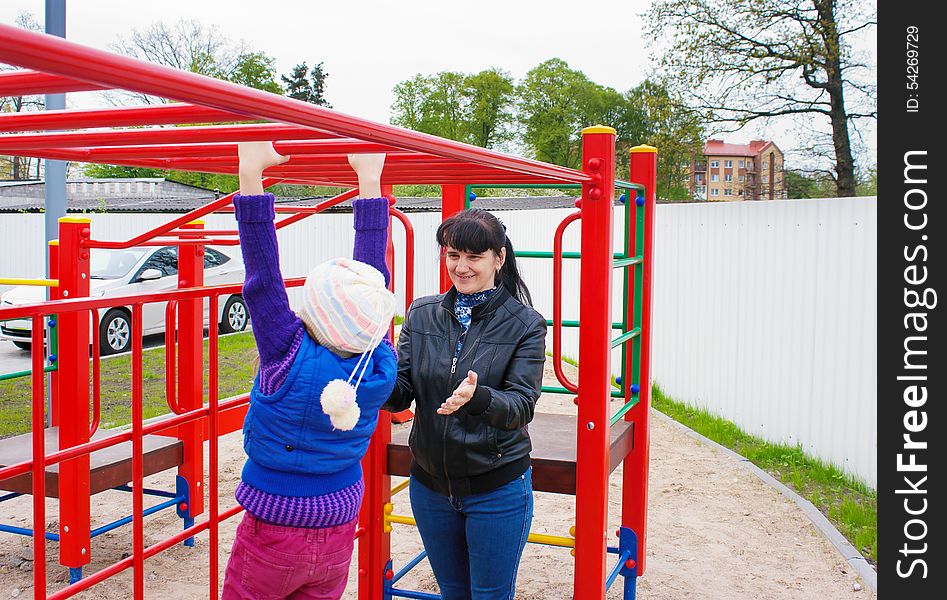 Mother playing with her daughter on the playground