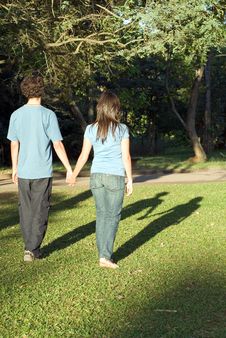 Couple Walking Through A Park - Vertical Stock Photo Couple Walking Through A Park - Vertical Stock Photo