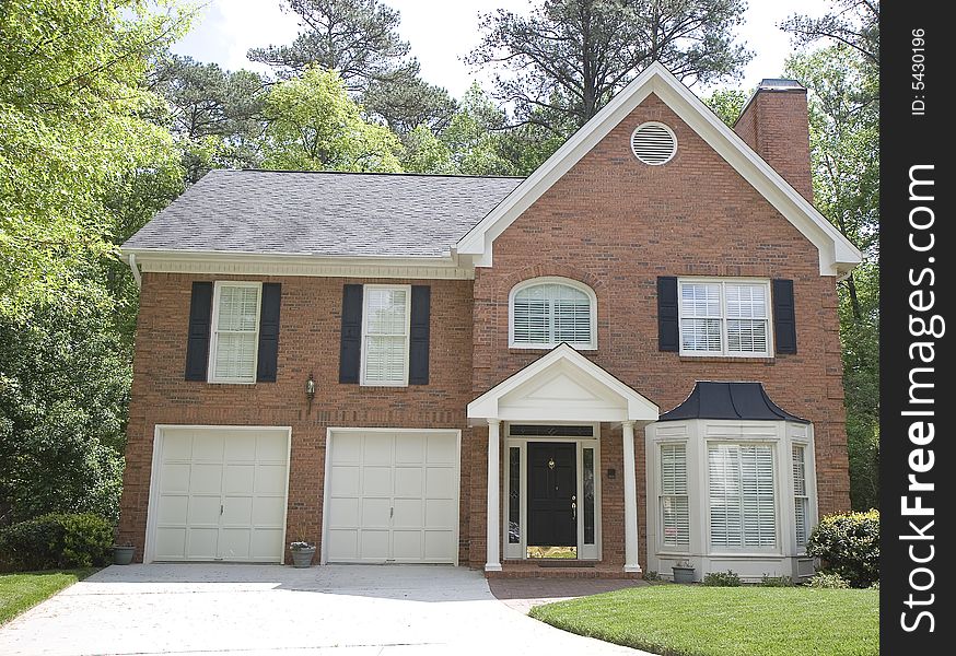 A nice brick house with a round attic vent. A nice brick house with a round attic vent