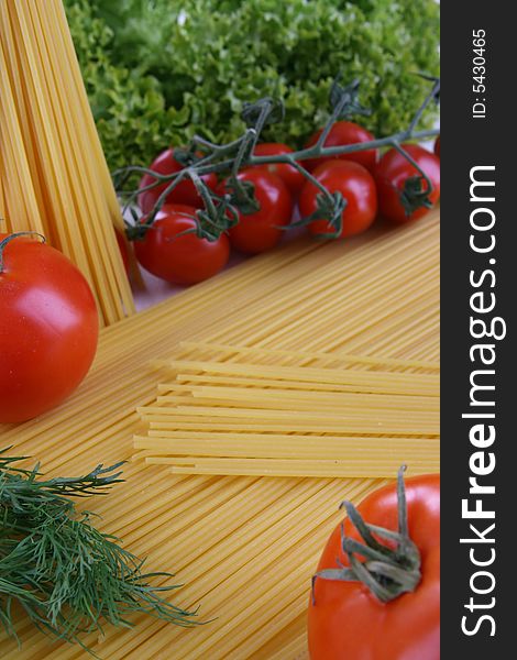 Tomatoes, fennel, lettuce and pasta on the table. Tomatoes, fennel, lettuce and pasta on the table