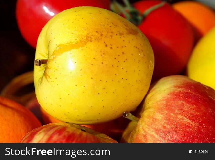 This is the picture of colorful, energy and vitamins full fruits close-up with the water drops on . Yellow and red apples have the water drops . This is the picture of colorful, energy and vitamins full fruits close-up with the water drops on . Yellow and red apples have the water drops .