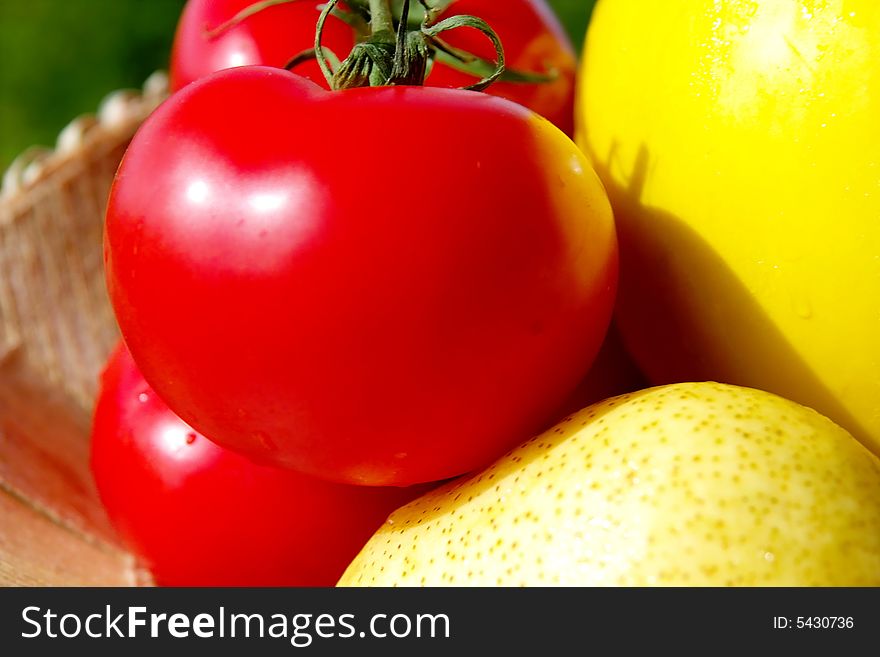 This is the closed-up picture of fresh Colorful, energy and vitamins full fruits closed . The red tomatoes are on central part of picture . The fruits are in cane basket. This is the closed-up picture of fresh Colorful, energy and vitamins full fruits closed . The red tomatoes are on central part of picture . The fruits are in cane basket.