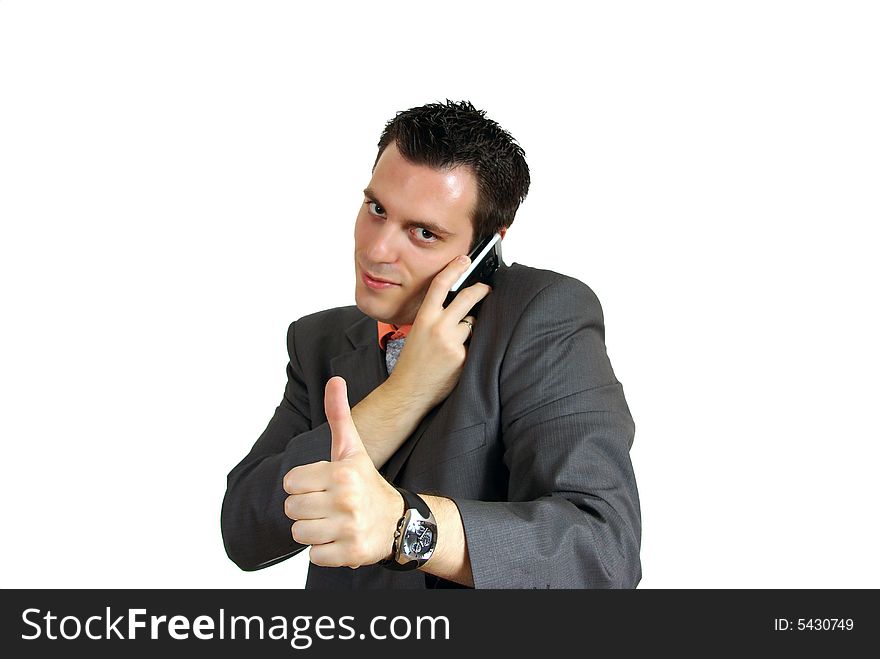 A young business man, talking over a cellphone, holding his thumb up. A young business man, talking over a cellphone, holding his thumb up