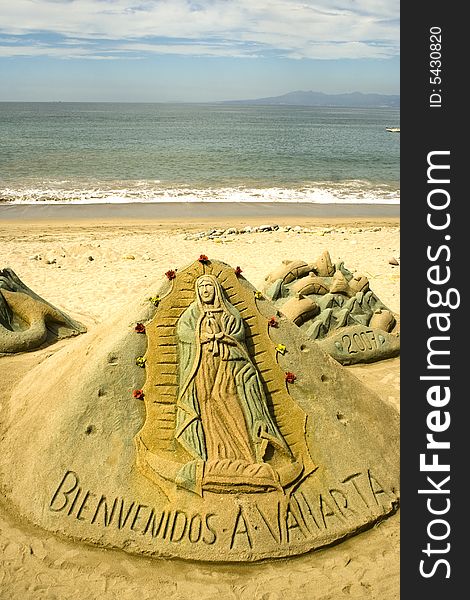 Virgen of Guadalupe sculpted in sand along the beach at Puerto Vallarta