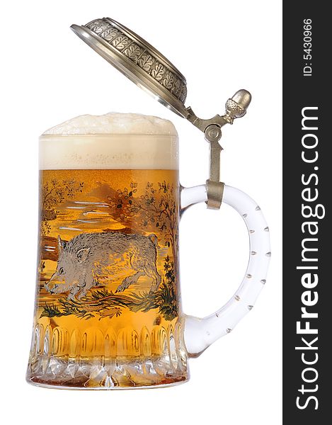 Souvenir glass with the image of the wild nature, filled by beer, with the slightly opened cover. Souvenir glass with the image of the wild nature, filled by beer, with the slightly opened cover