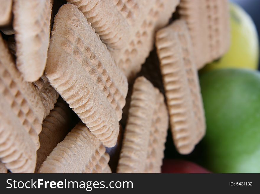 Small biscuits and fruits in the background