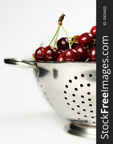 Fresh cherry in Colander on white background. Fresh cherry in Colander on white background