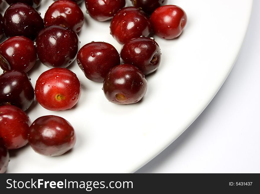 Close-up of fresh cherry on white plate