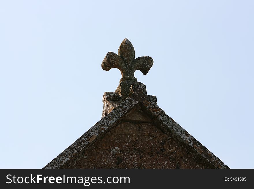 A Stone Plume sits o nthe gable of a chrch roof in Somerset. A Stone Plume sits o nthe gable of a chrch roof in Somerset