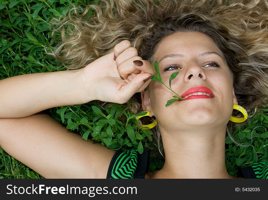 Beautiful girl lying down of grass and relaxing