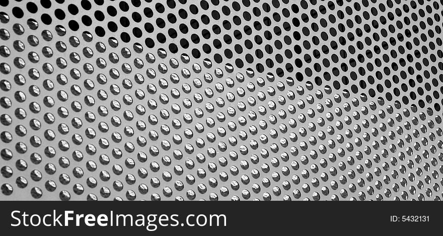 Graphic design detail of a grid in aluminum on a building surface