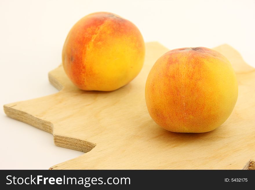 Peaches on woody kitchen board