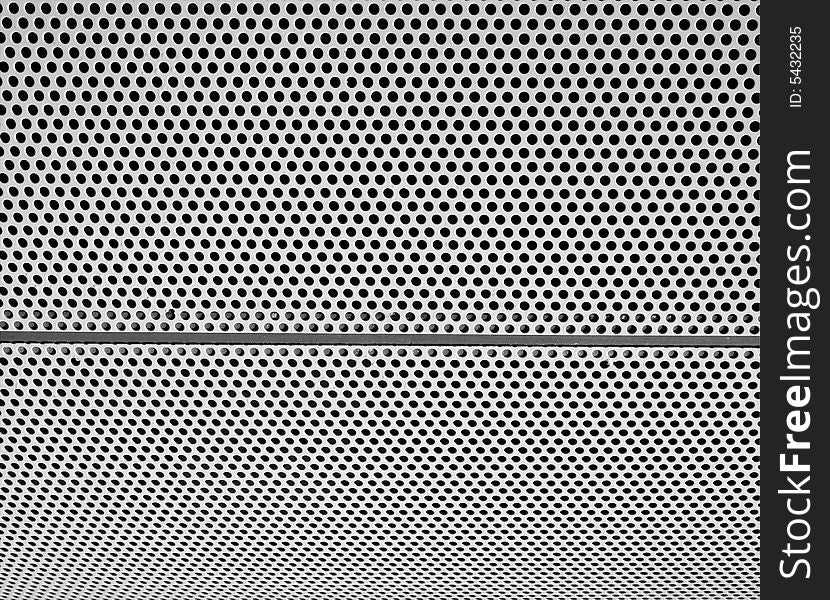 Graphic design detail of a grid in aluminum on a building surface