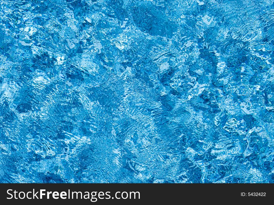 The surface of blue water as it is being blown by the wind. The surface of blue water as it is being blown by the wind.