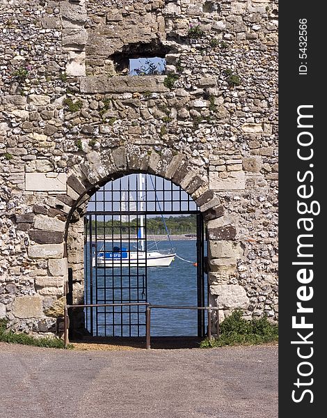 A boat framed by a castle gate. A boat framed by a castle gate