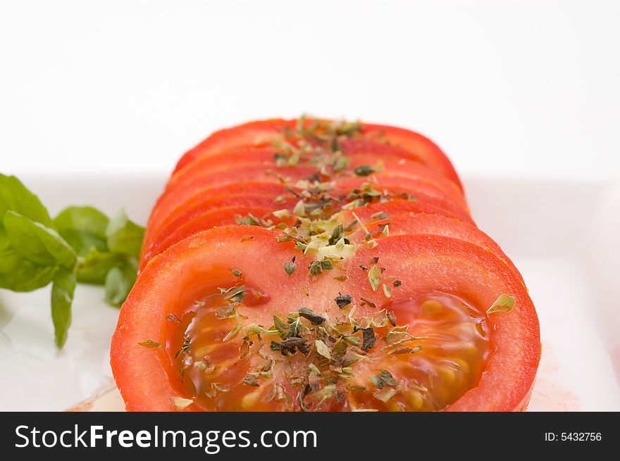 Tomato slices with basil and oregano