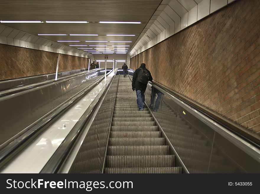 A men on an escalator from subway in Munich. A men on an escalator from subway in Munich