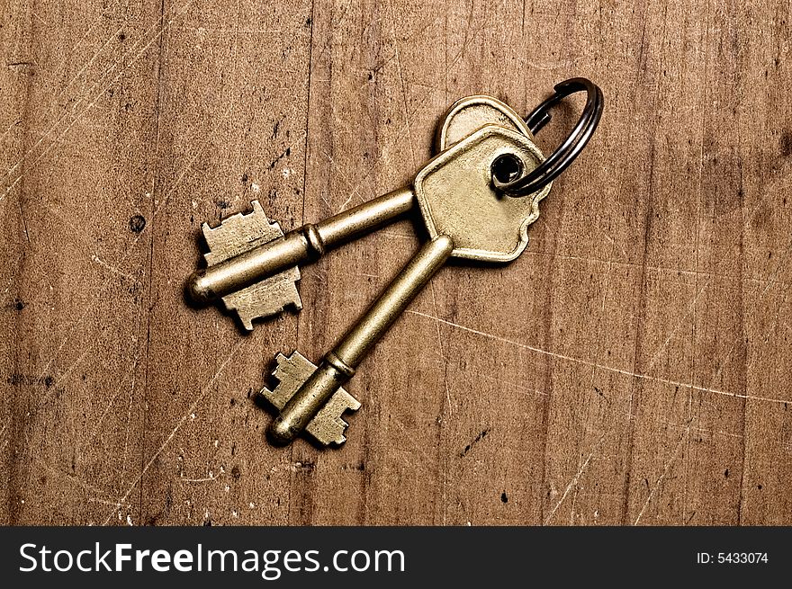 Bronze keys on wooden table. Bronze keys on wooden table.