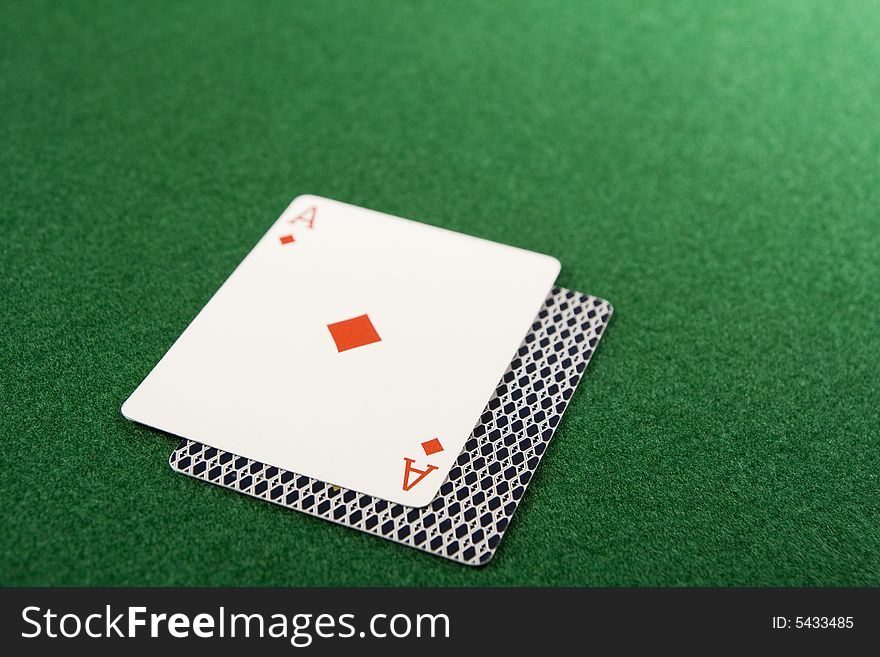 Blackjack hand with ace facing up on green felt table. Blackjack hand with ace facing up on green felt table.