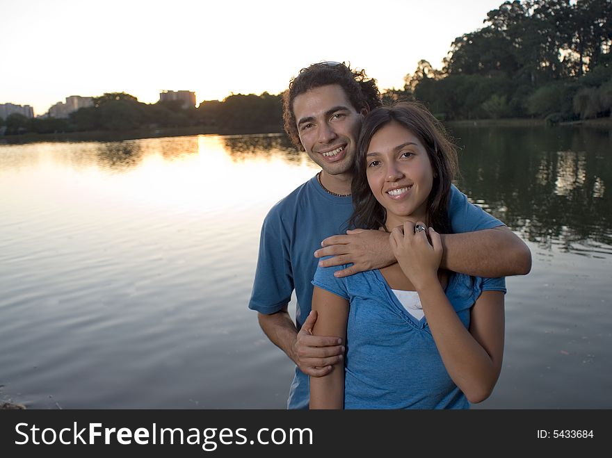 Couple Embracing by a Pond - Horizontal