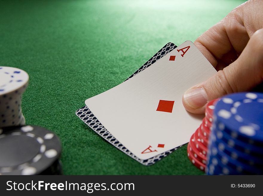 Blackjack hand with Ace of diamonds and gambling chips on a green felt table.