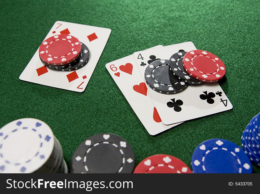 Blackjack hand doubled with Seven, Six, and Four.  Gambling chips scattered over a green felt table.