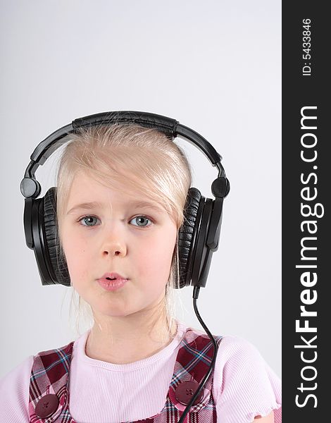 Small girl listening to music on headset. Small girl listening to music on headset