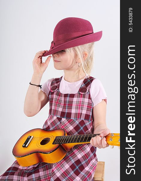 Small girl playing a toy guitar. Small girl playing a toy guitar