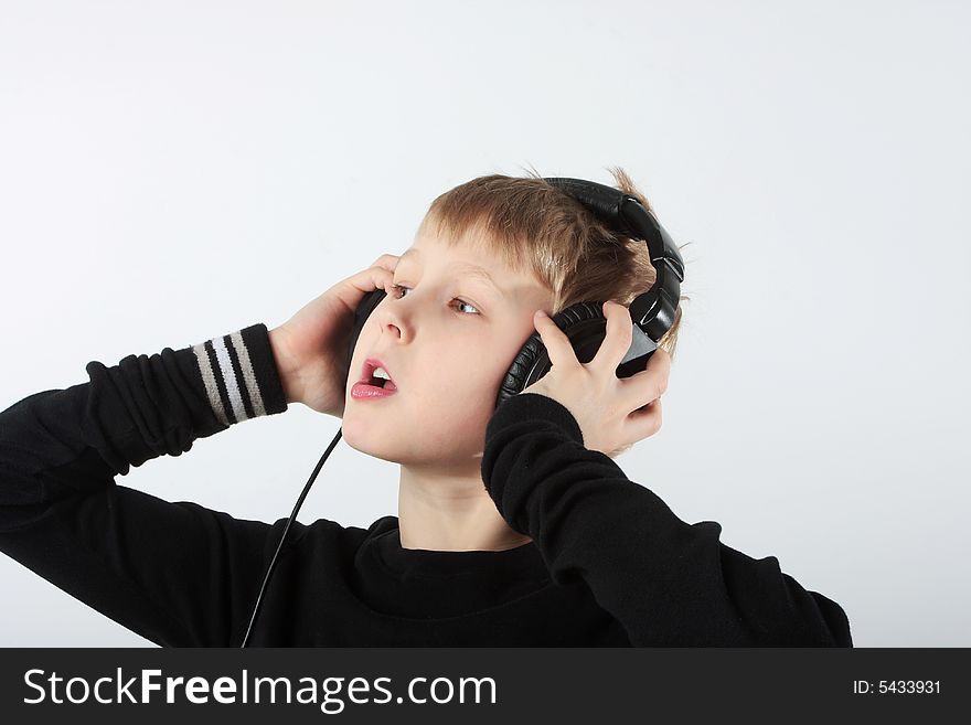 Young boy listening to music in headphones. Young boy listening to music in headphones