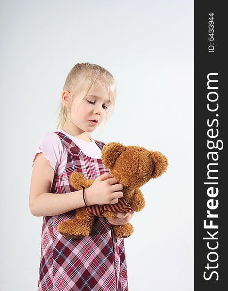 A little girl talking to her teddy bear. A little girl talking to her teddy bear