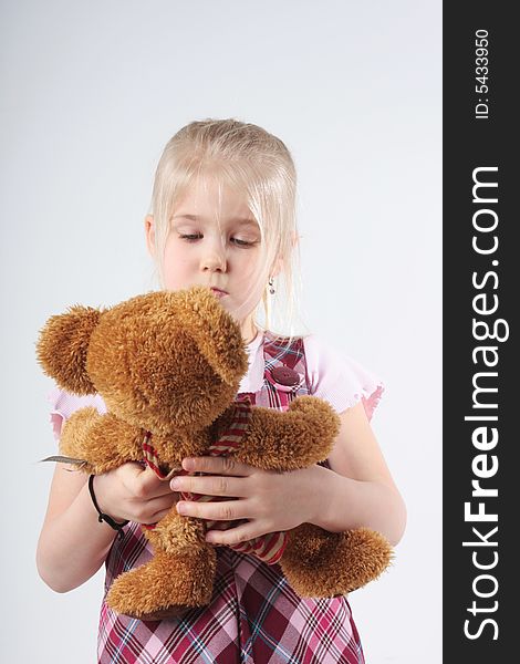 A little girl playing with her teddy bear. A little girl playing with her teddy bear