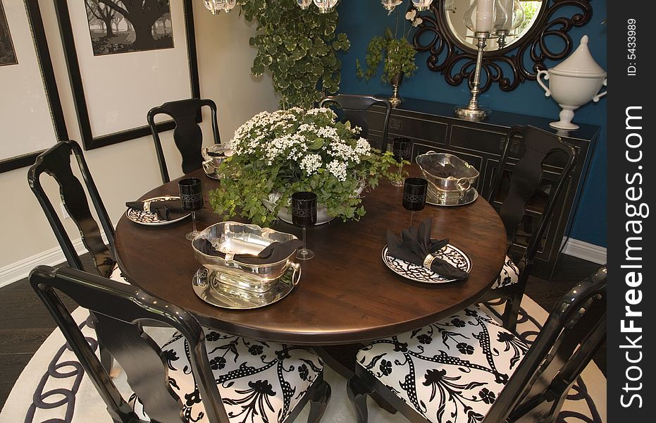 Luxury home dining table with modern tableware. Luxury home dining table with modern tableware.