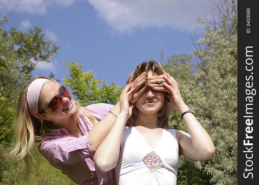 Two beautiful cheerful women on the nature. Two beautiful cheerful women on the nature