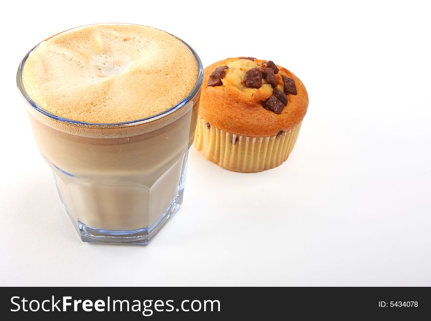 A shot of a a cup of coffee with muffins. A shot of a a cup of coffee with muffins